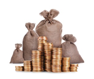 Image of Wealth. Stacked coins and burlap bags isolated on white
