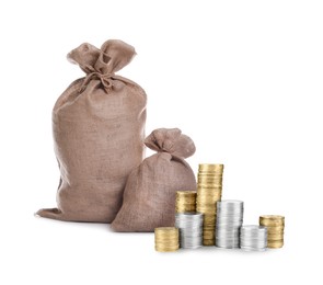 Image of Wealth. Stacked coins and burlap bags isolated on white