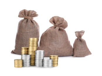 Image of Wealth. Stacked coins and burlap bags isolated on white