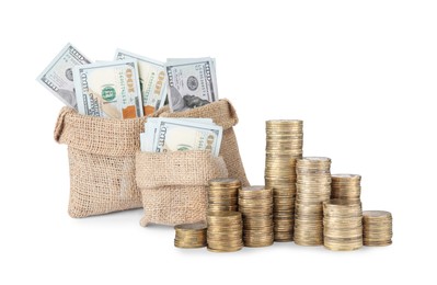 Image of Wealth. Burlap bags full of dollar bills and stacked coins isolated on white