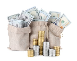 Image of Wealth. Burlap bags full of dollar bills and stacked coins isolated on white