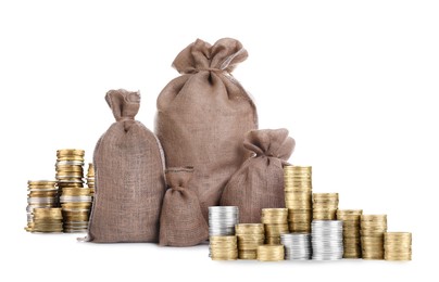 Image of Wealth. Stacked coins and burlap bags isolated on white