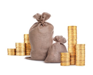 Image of Wealth. Stacked coins and burlap bags isolated on white