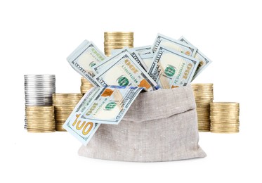 Image of Wealth. Burlap bag full of dollar bills and stacked coins isolated on white