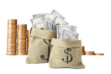 Image of Wealth. Burlap bags full of dollar bills and stacked coins isolated on white