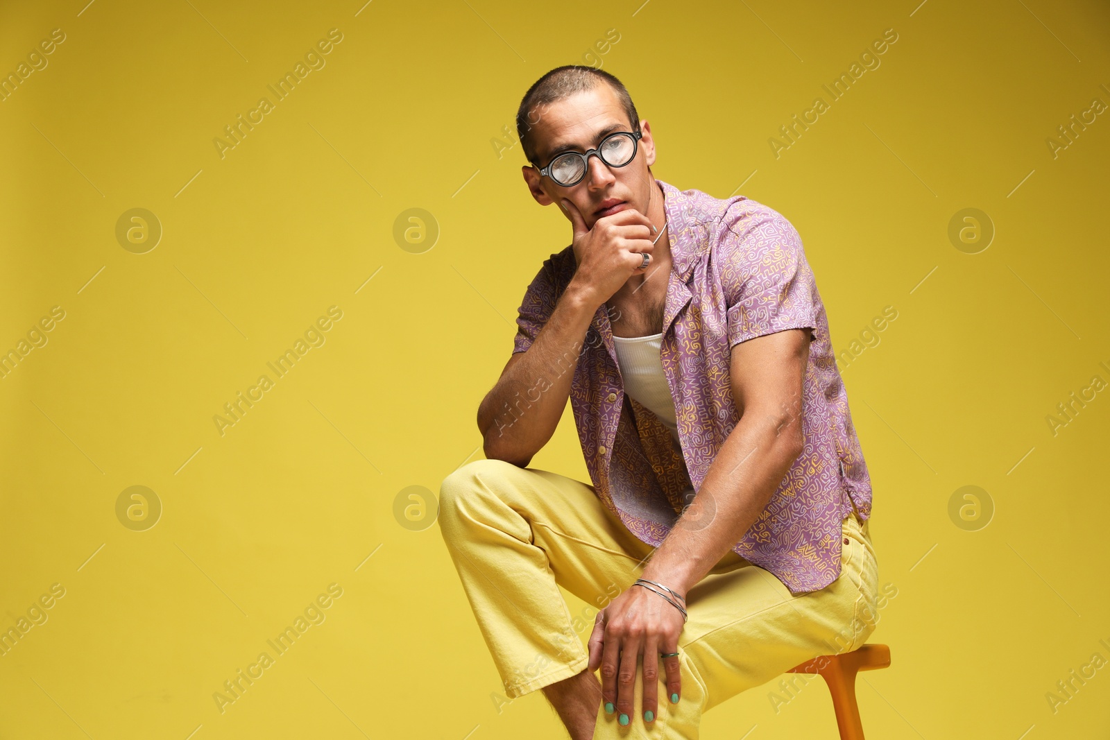 Fashionable portrait of handsome man in stylish outfit on color background, space for text Photo of Fashionable portrait of handsome man in stylish outfit on color background, space for text