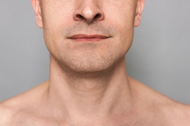 Photo of Man after shaving on grey background, closeup