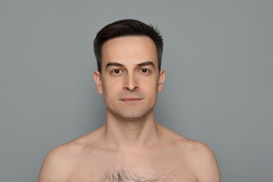 Photo of Portrait of man after shaving on grey background