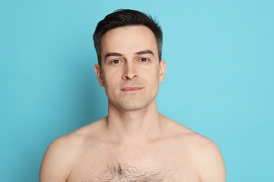 Photo of Handsome man after shaving on light blue background