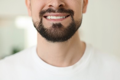 Photo of Smiling man before shaving on blurred background, closeup