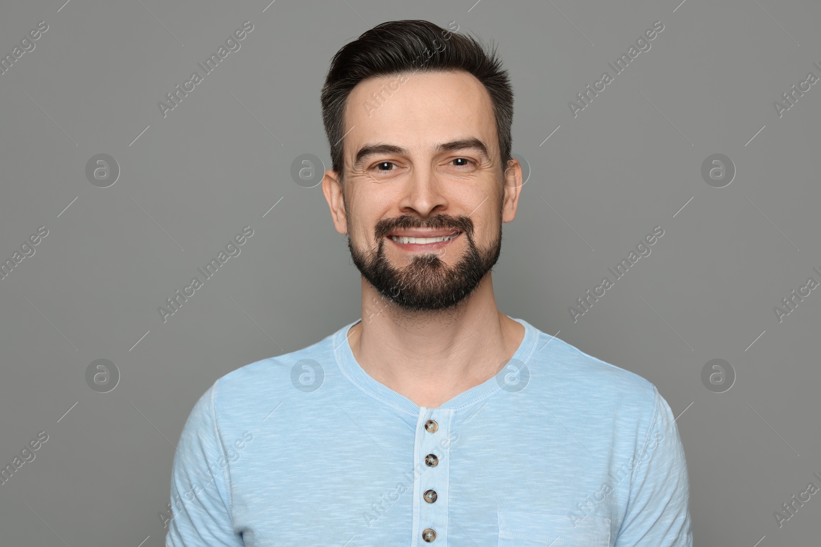 Smiling man before shaving on grey background Photo of Smiling man before shaving on grey background