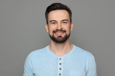 Photo of Smiling man before shaving on grey background