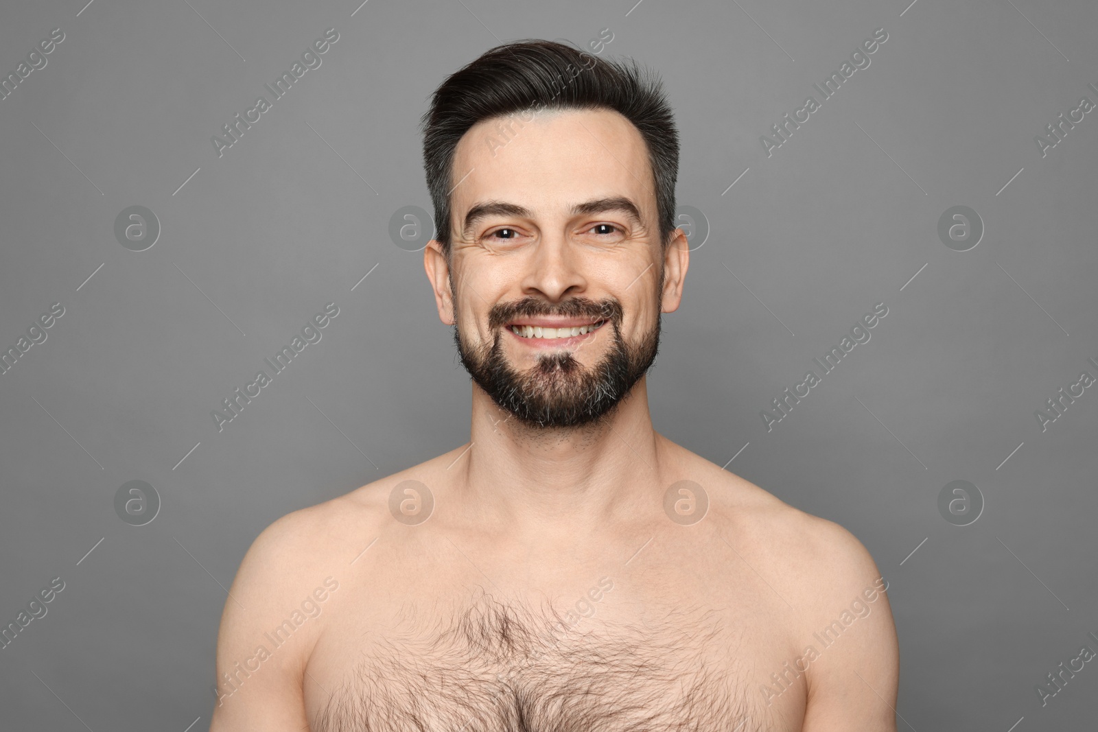 Smiling man before shaving on grey background Photo of Smiling man before shaving on grey background