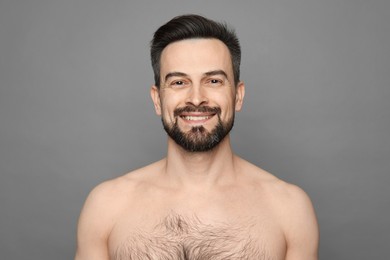 Photo of Smiling man before shaving on grey background