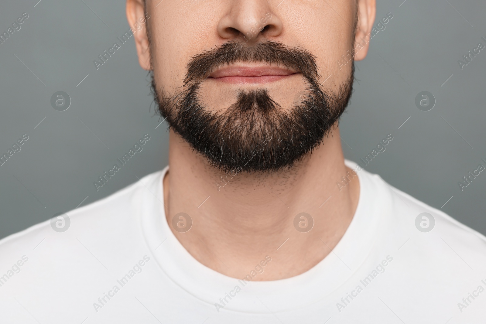 Man before shaving on grey background, closeup Photo of Man before shaving on grey background, closeup