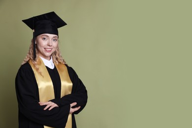 Photo of Happy student after graduation on green background. Space for text