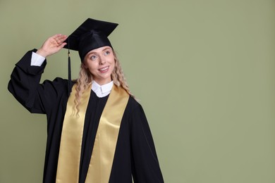 Photo of Happy student after graduation on green background. Space for text