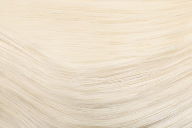 Image of Beautiful shiny blonde straight hair as background, closeup