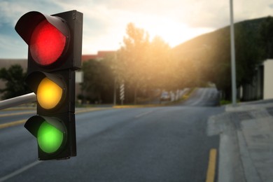 Image of Traffic lights on empty road. Signaling device