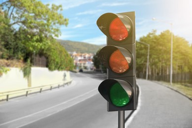 Image of Traffic lights on empty road. Signaling device