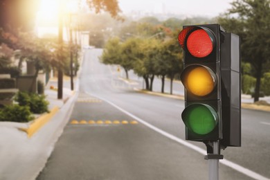 Image of Traffic lights on empty road. Signaling device