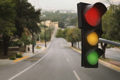 Image of Traffic lights on empty road. Signaling device