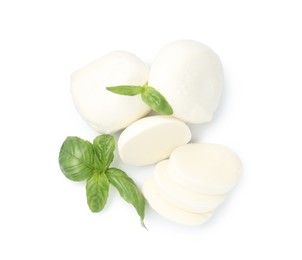 Photo of Pieces of mozzarella cheese and basil isolated on white, top view