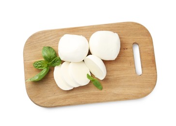 Photo of Pieces of mozzarella cheese and basil isolated on white, top view