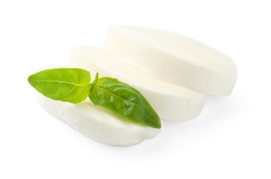 Photo of Pieces of mozzarella cheese and basil isolated on white