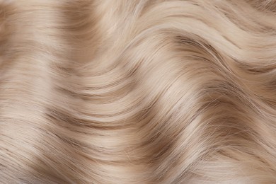 Image of Beautiful shiny blonde hair as background, top view