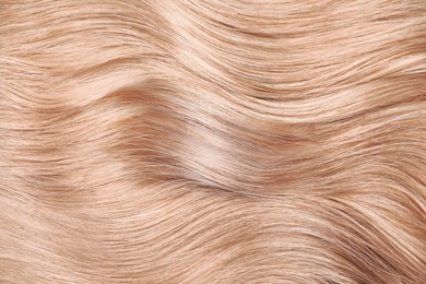Image of Beautiful shiny blonde hair as background, top view