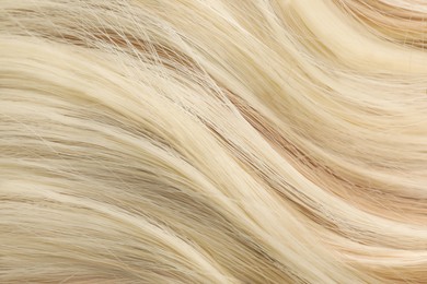 Image of Beautiful shiny blonde hair as background, top view