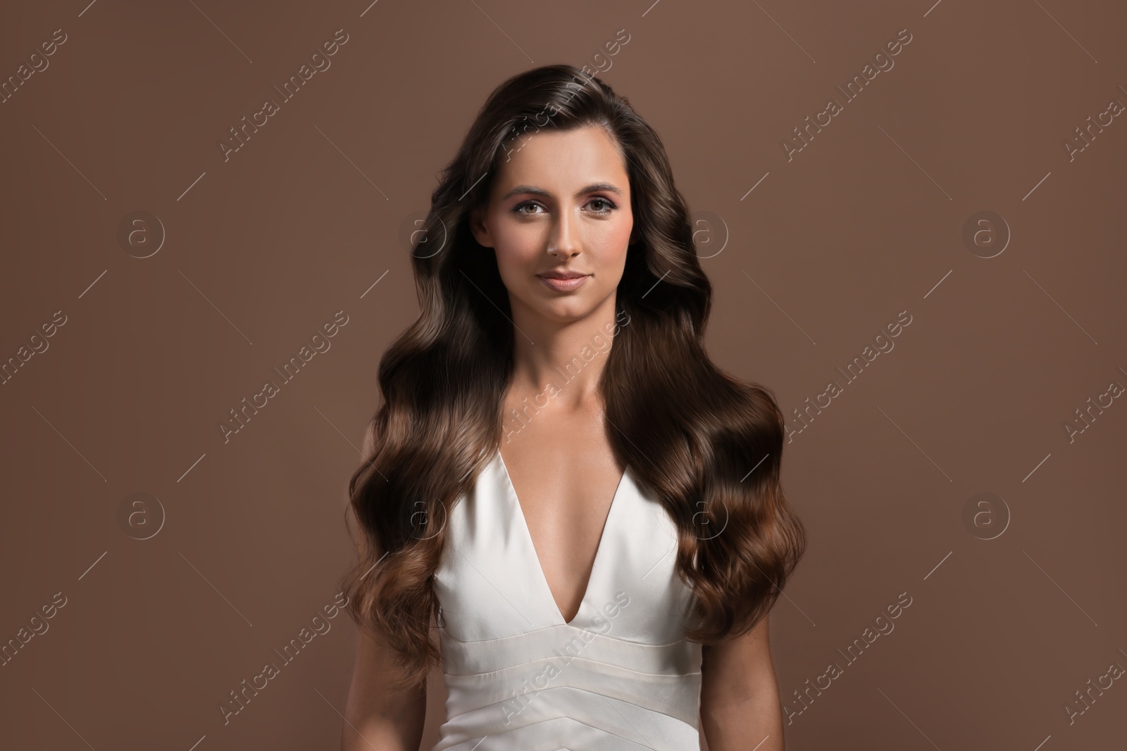 Beautiful woman with shiny healthy hair on pale brown background Image of Beautiful woman with shiny healthy hair on pale brown background