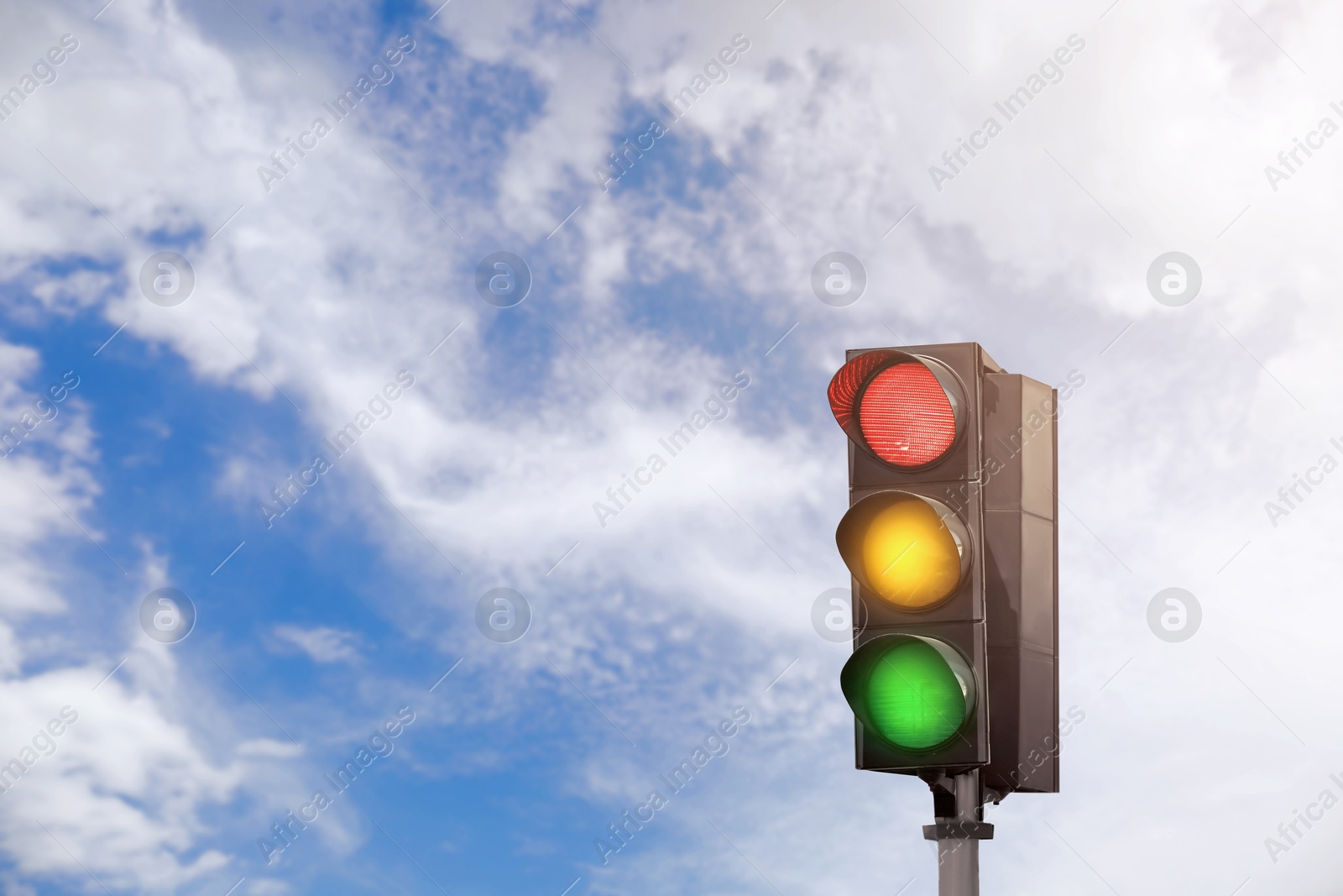 Traffic lights against blue sky with clouds Image of Traffic lights against blue sky with clouds