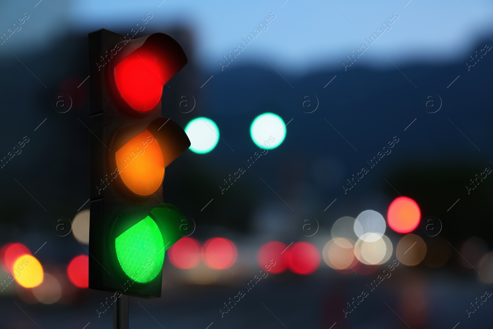 Traffic lights on city street in evening, bokeh effect . Signaling device Image of Traffic lights on city street in evening, bokeh effect . Signaling device