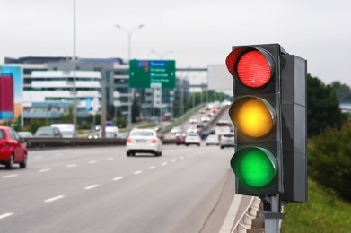 Image of Traffic lights on busy highway. Signaling device