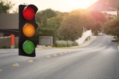 Image of Traffic lights on empty road. Signaling device