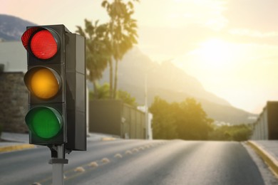 Image of Traffic lights on empty road. Signaling device