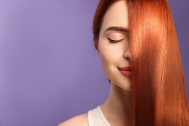 Image of Beautiful young woman with shiny healthy red hair on violet background