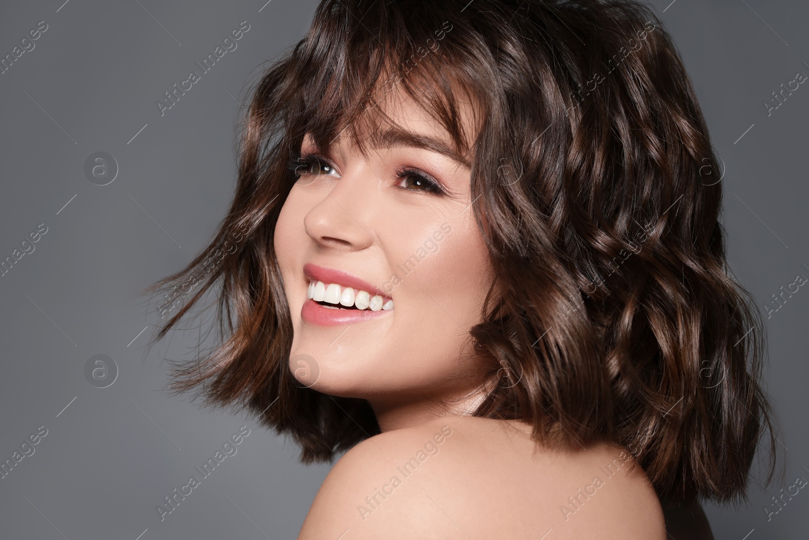 Beautiful young woman with shiny healthy hair on grey background Image of Beautiful young woman with shiny healthy hair on grey background