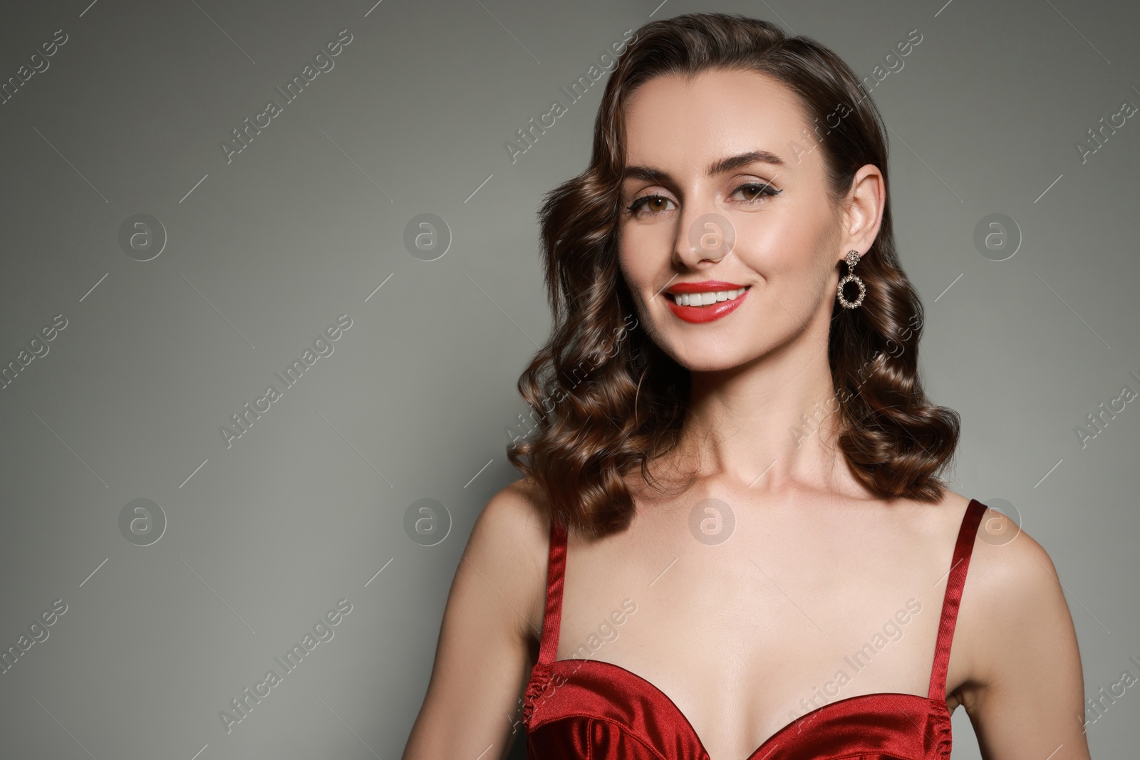Gorgeous woman with shiny healthy hair on grey background Image of Gorgeous woman with shiny healthy hair on grey background