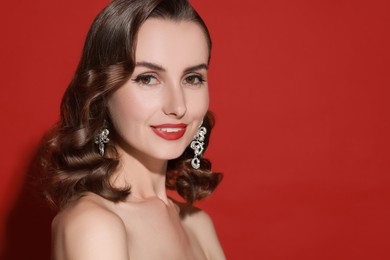 Image of Attractive woman with shiny healthy hair on red background