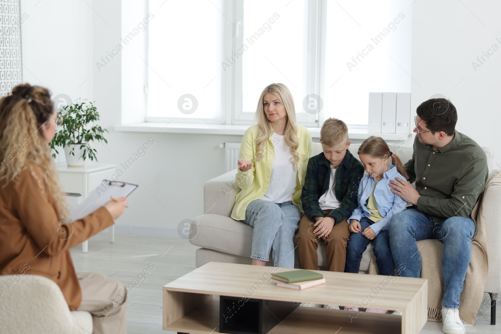 Family having consultation with psychologist in office Photo of Family having consultation with psychologist in office