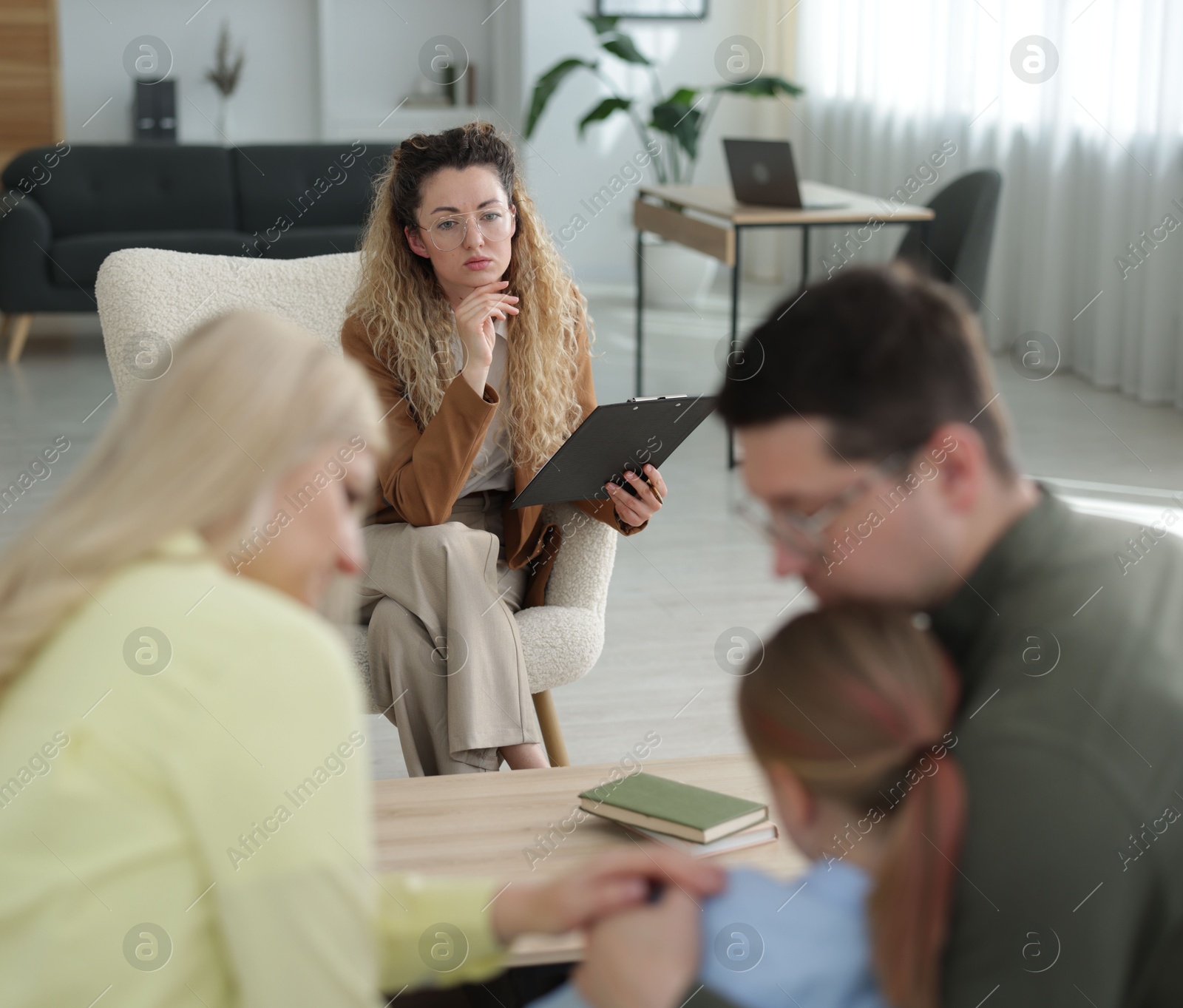 Family having consultation with psychologist in office, selective focus Photo of Family having consultation with psychologist in office, selective focus