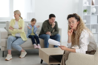 Photo of Family having consultation with psychologist in office, selective focus