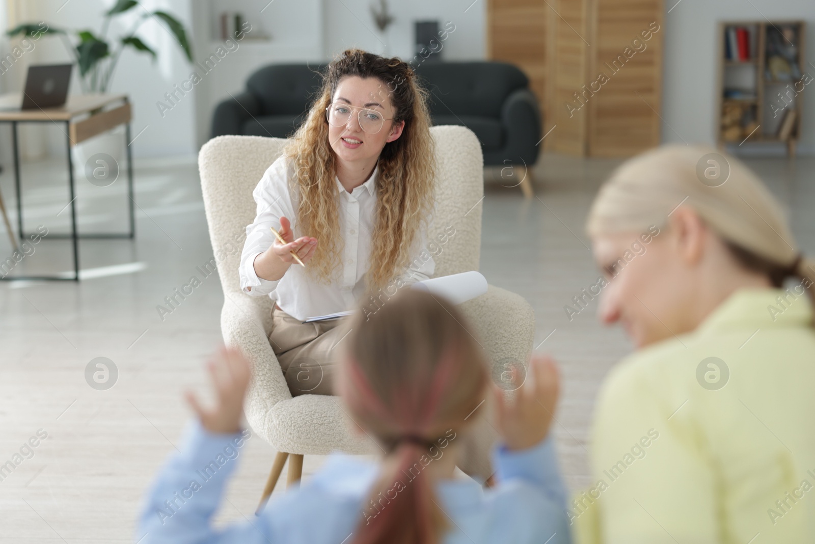 Mother and daughter having consultation with psychologist in office, selective focus Photo of Mother and daughter having consultation with psychologist in office, selective focus
