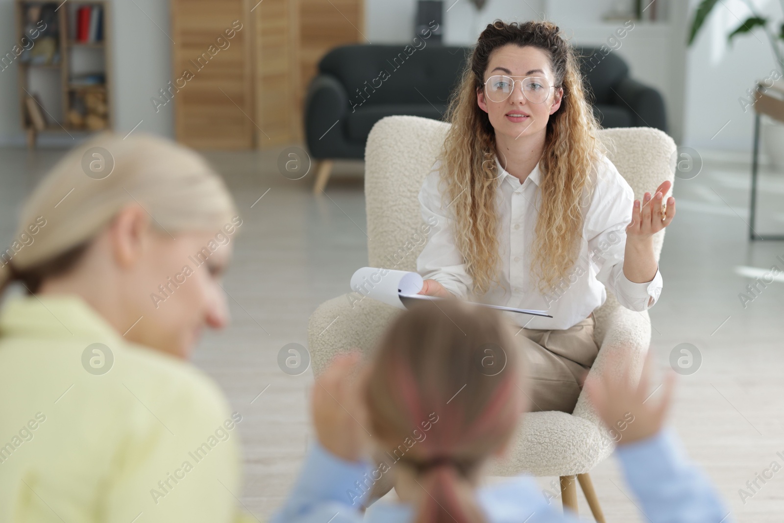 Mother and daughter having consultation with psychologist in office, selective focus Photo of Mother and daughter having consultation with psychologist in office, selective focus
