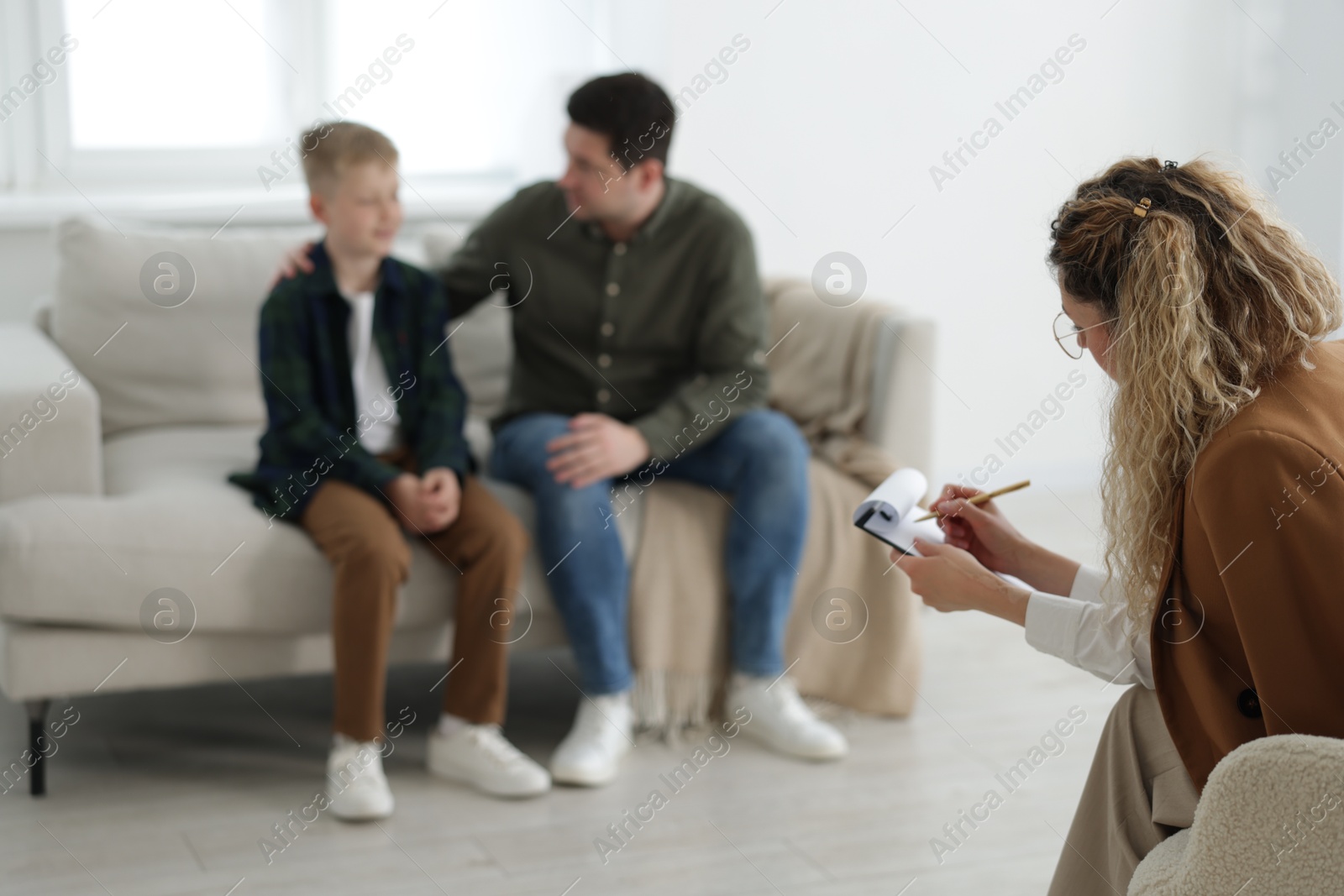 Father and son having consultation with psychologist in office, selective focus Photo of Father and son having consultation with psychologist in office, selective focus
