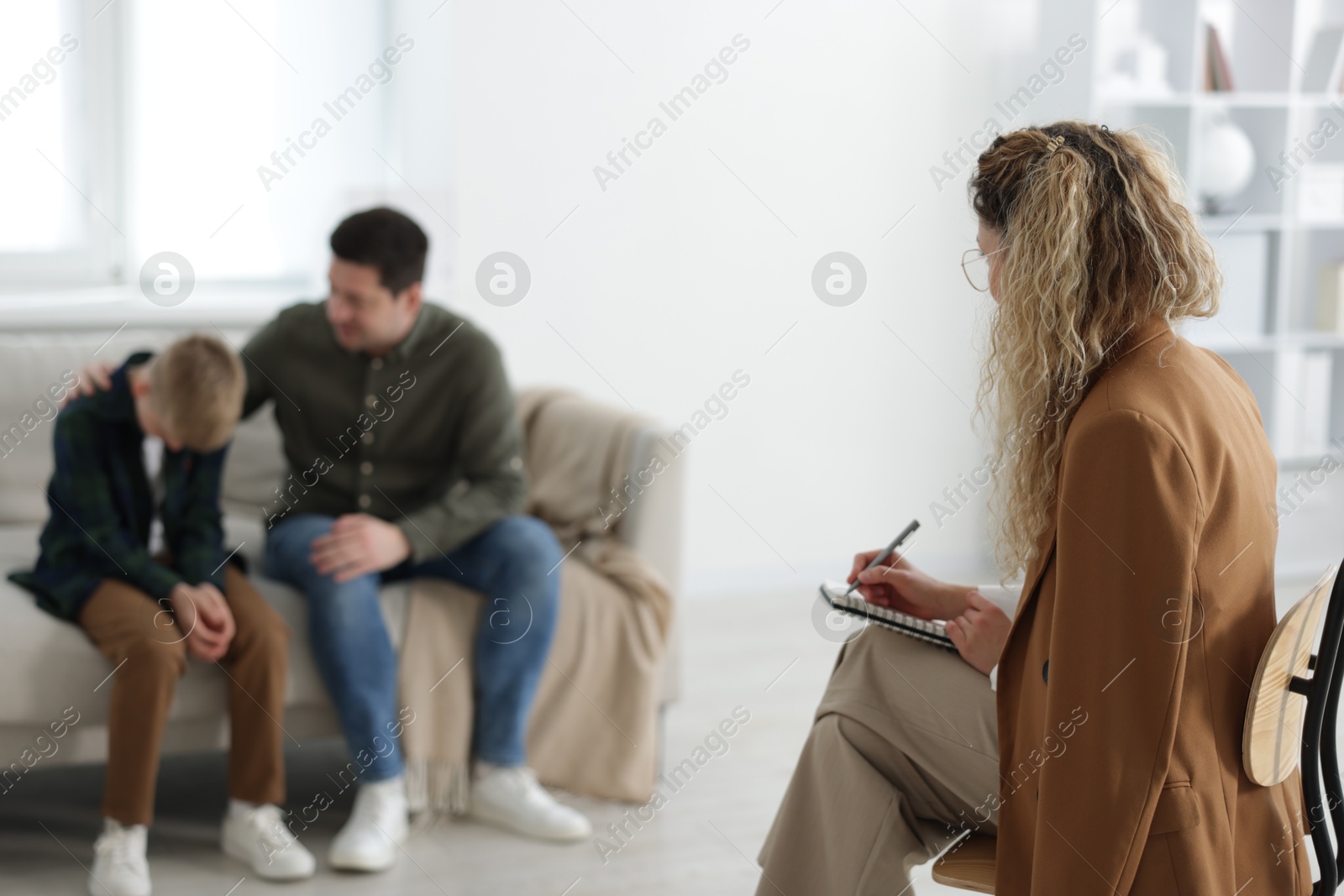 Father and son having consultation with psychologist in office, selective focus Photo of Father and son having consultation with psychologist in office, selective focus