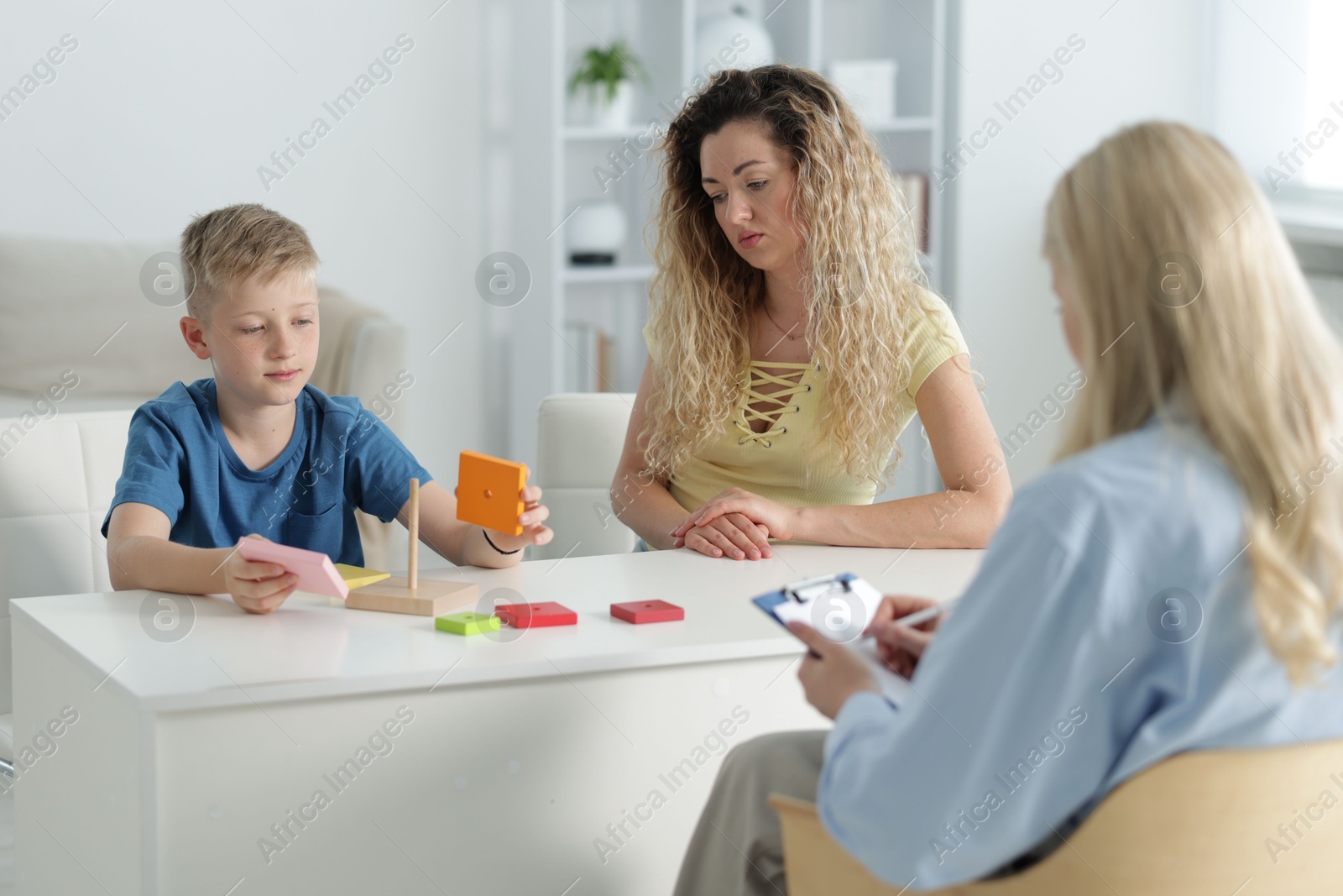 Mother and son having consultation with psychologist in office, selective focus Photo of Mother and son having consultation with psychologist in office, selective focus